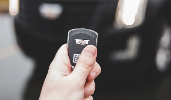 A replacement key fob being handed over after a car lockout